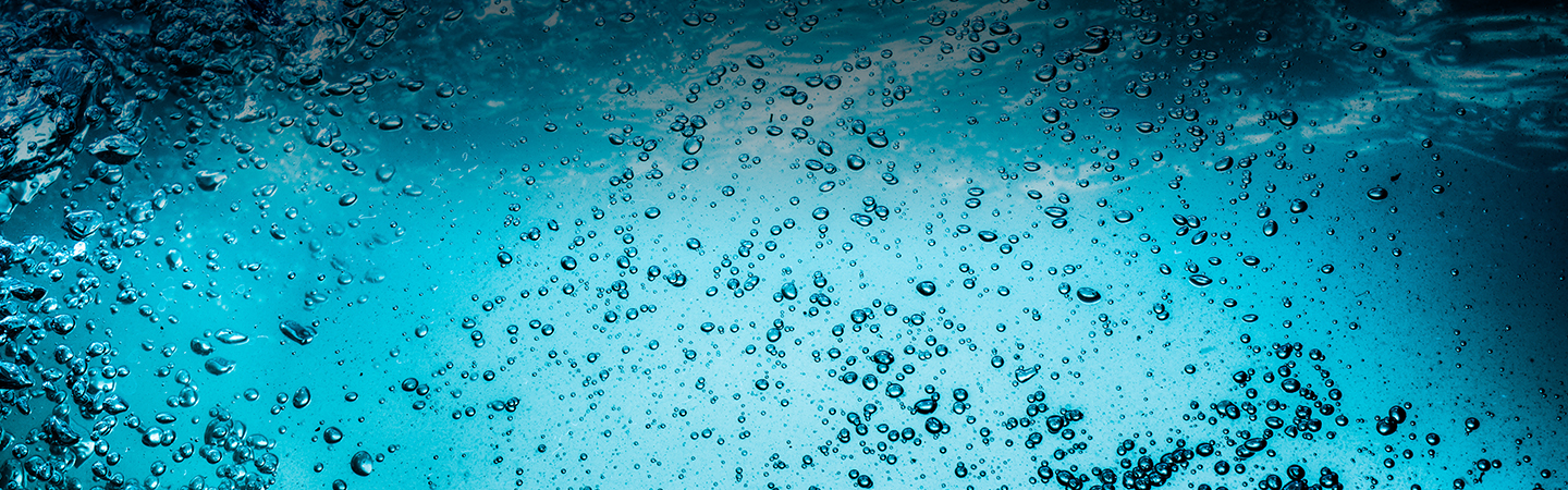 Hero Image Many bubbles in water close up, abstract water wave with bubbles