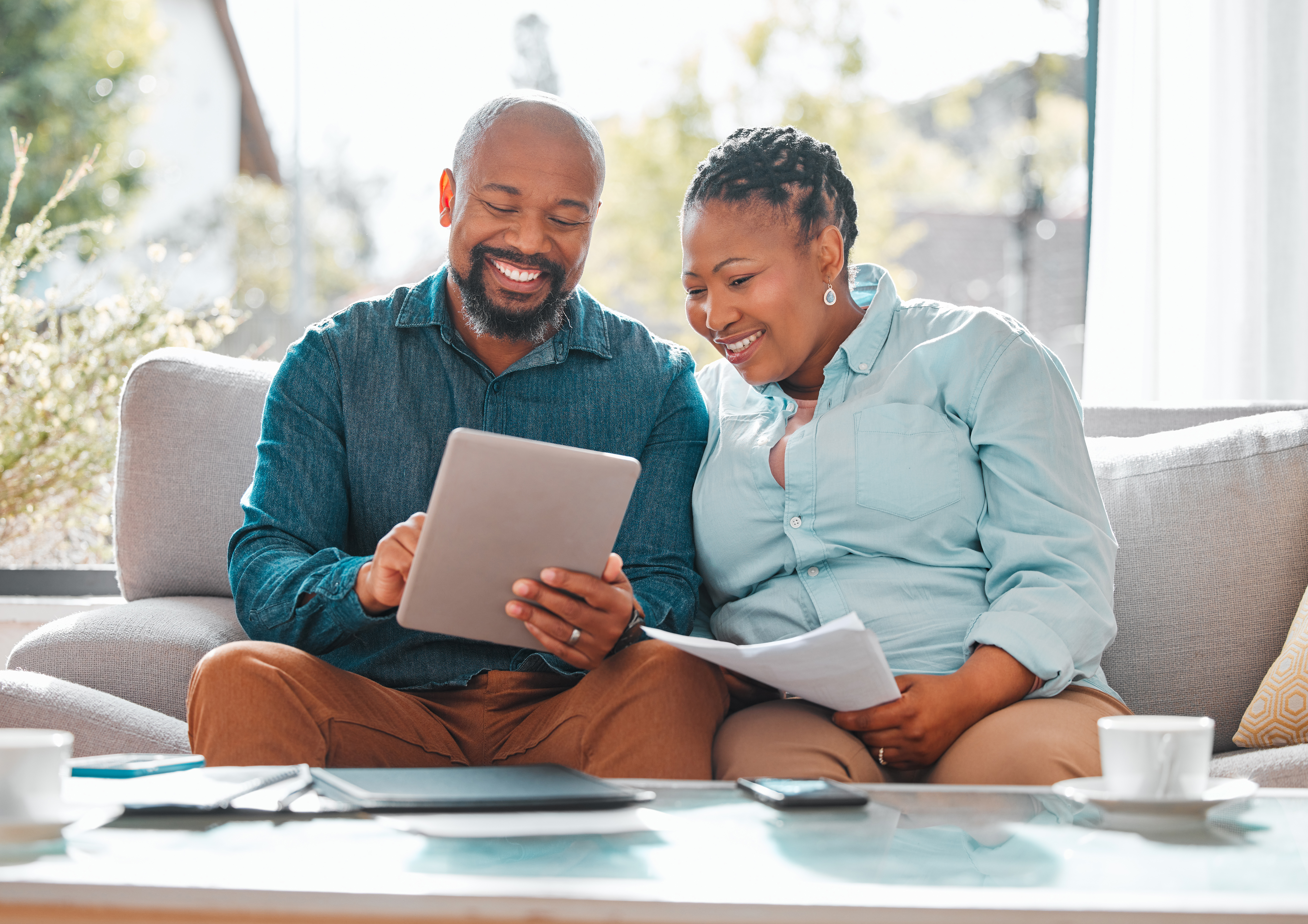 happy couple in living room looking at documents