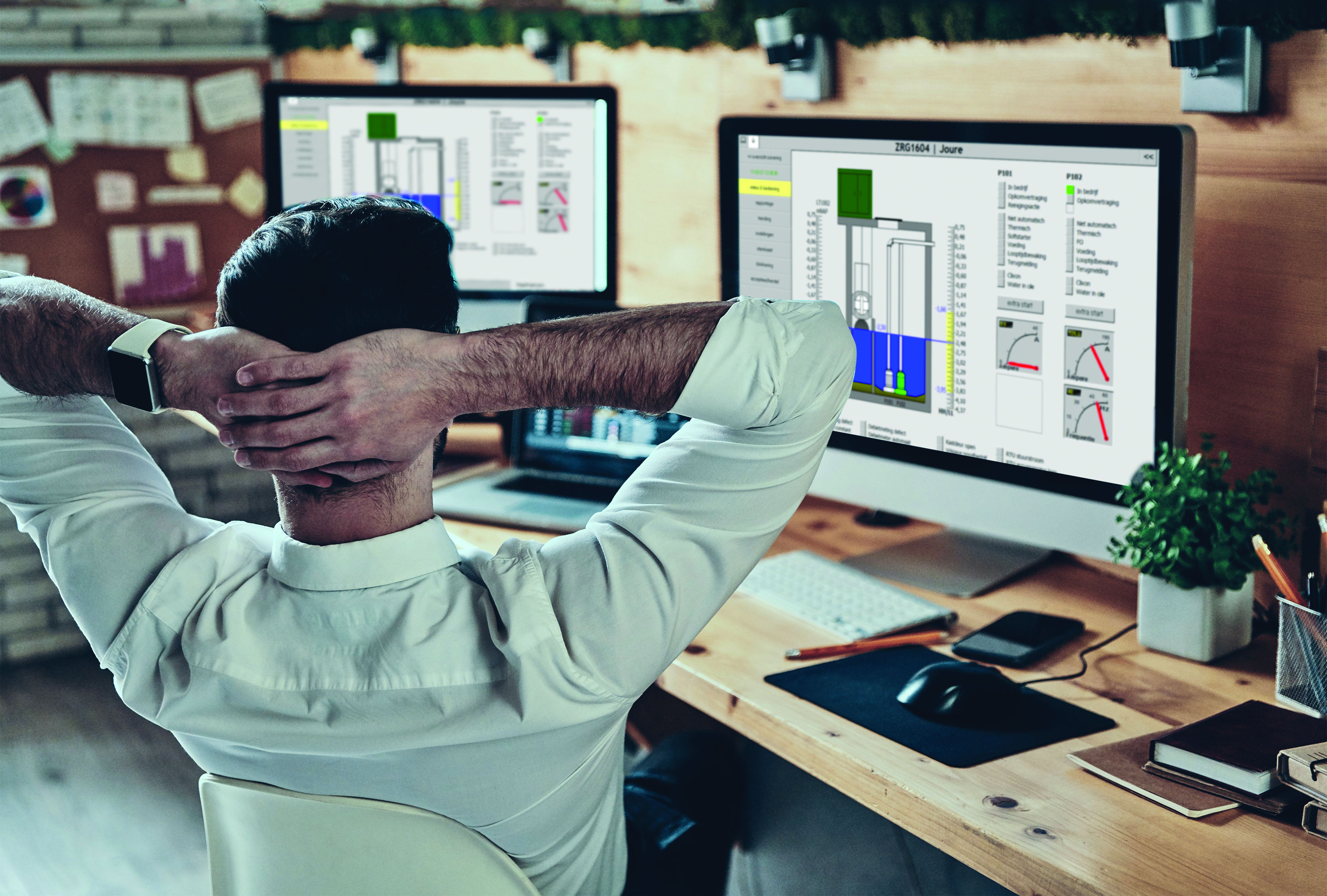 Rear view of young man in formalwear keeping hand behind head while sitting in the office; Adobe Stock: 338827218