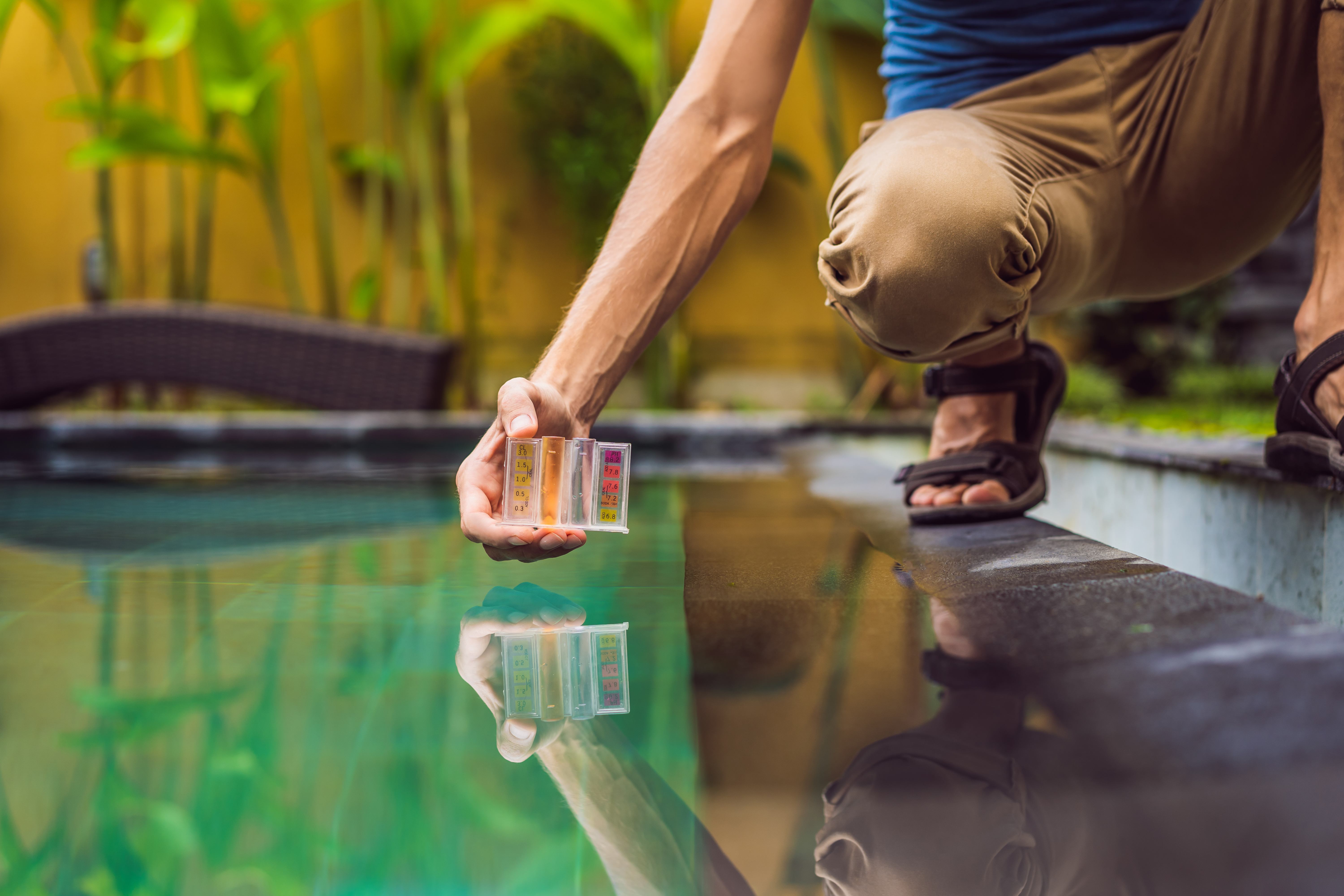 Pool worker checks the pool for safety. Measurement of chlorine and PH of a pool.