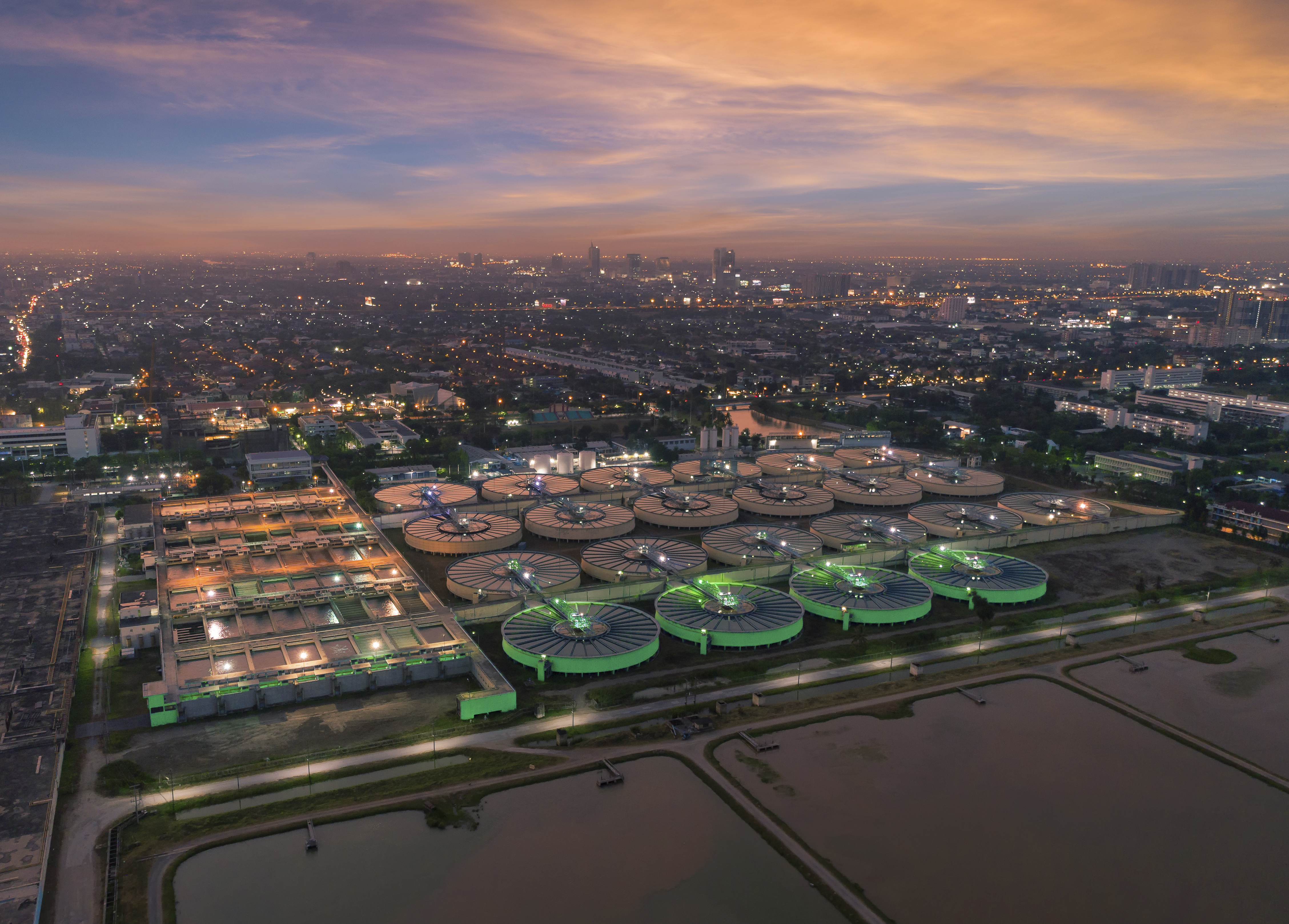 aerial-view-water-treatment-plant-at-dusk-with-cityscape-for-municipal-water-supply.jpg