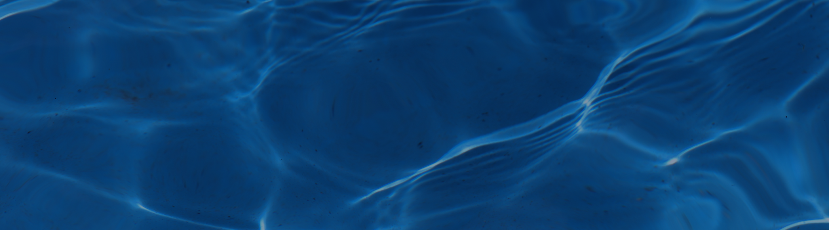 Pool water in motion with dark blue overlay