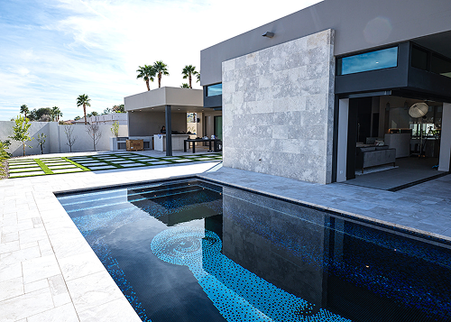 A dark pool with a keyhole and eye. Geometric house with pristine landscaping. 