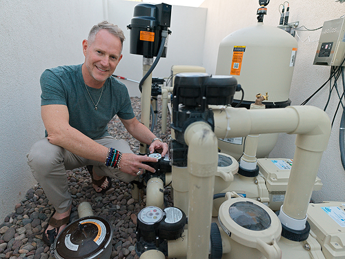 Jonny Moore beside a Pentair Pool System
