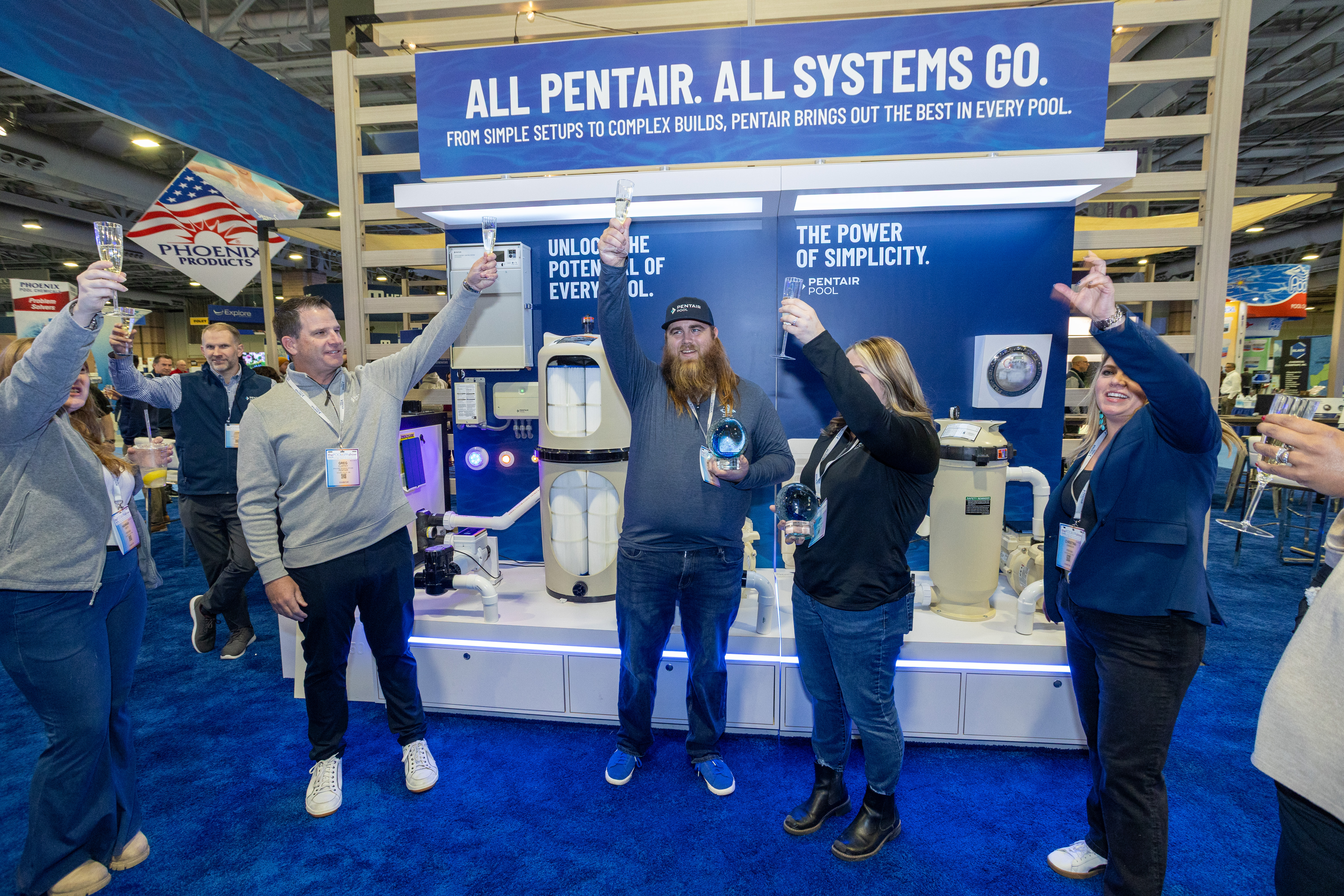 Jena Beach and Nick Lehman toasting with the Pentair Team. Photo courtesy of Nobile Photo.