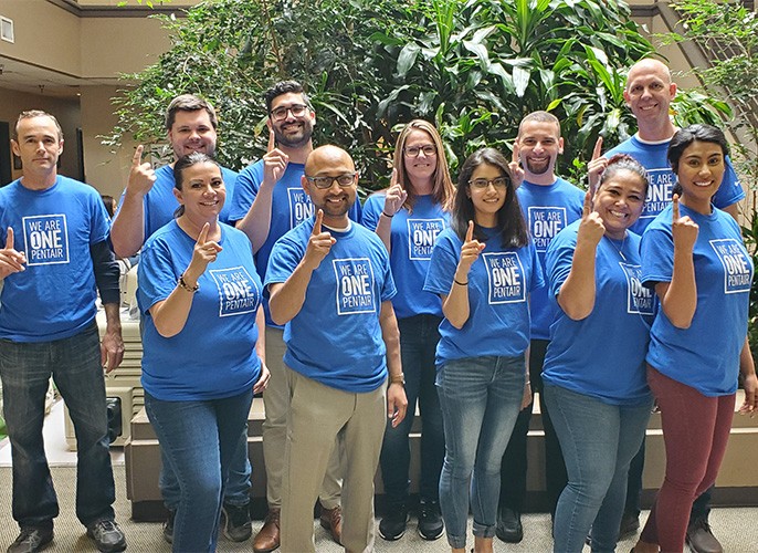 group of pentair employees in team pentair shirts indoors