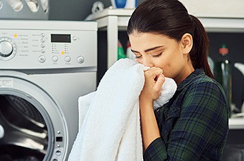 young-woman-laundry-fabric-softener-scent-horizontal-355x235-image-file