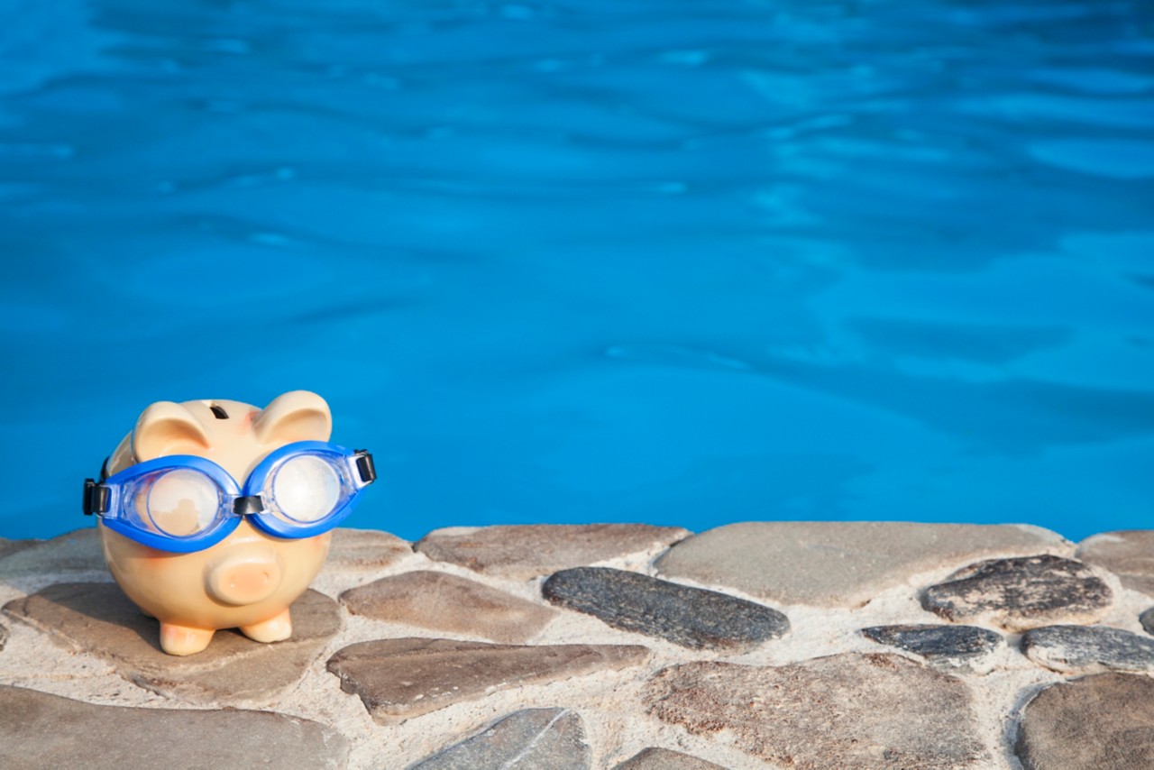 piggy bank with goggles by the pool
