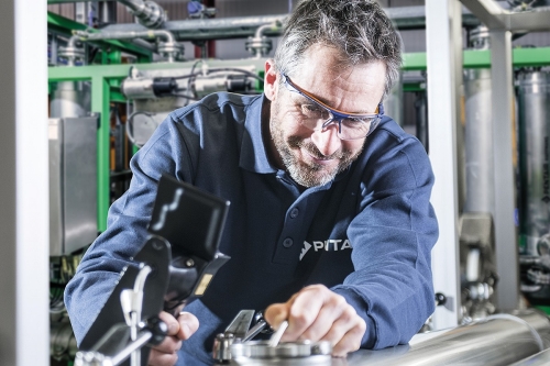 Man with beard adjusting equipment