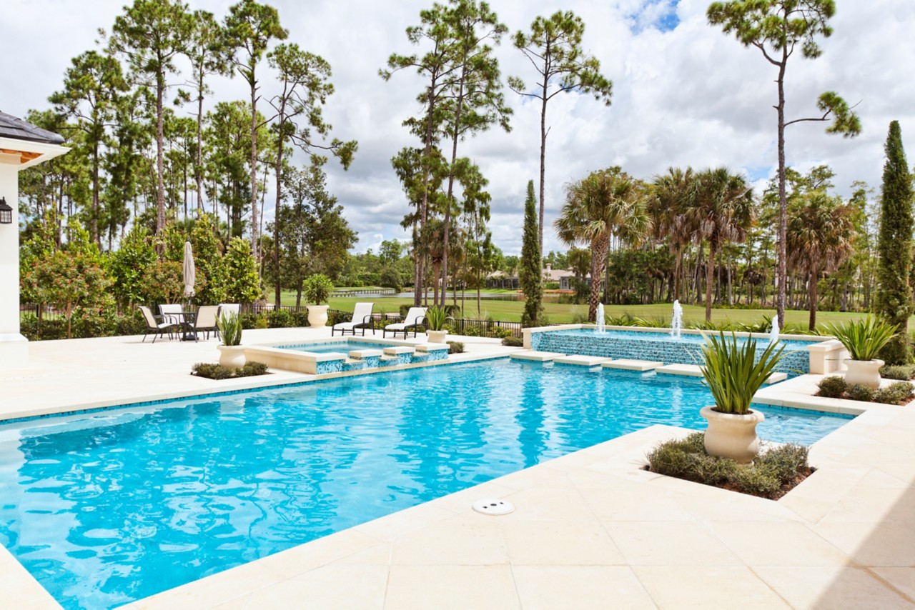 A beautiful swimming pool at an estate home overlooking a golf course.