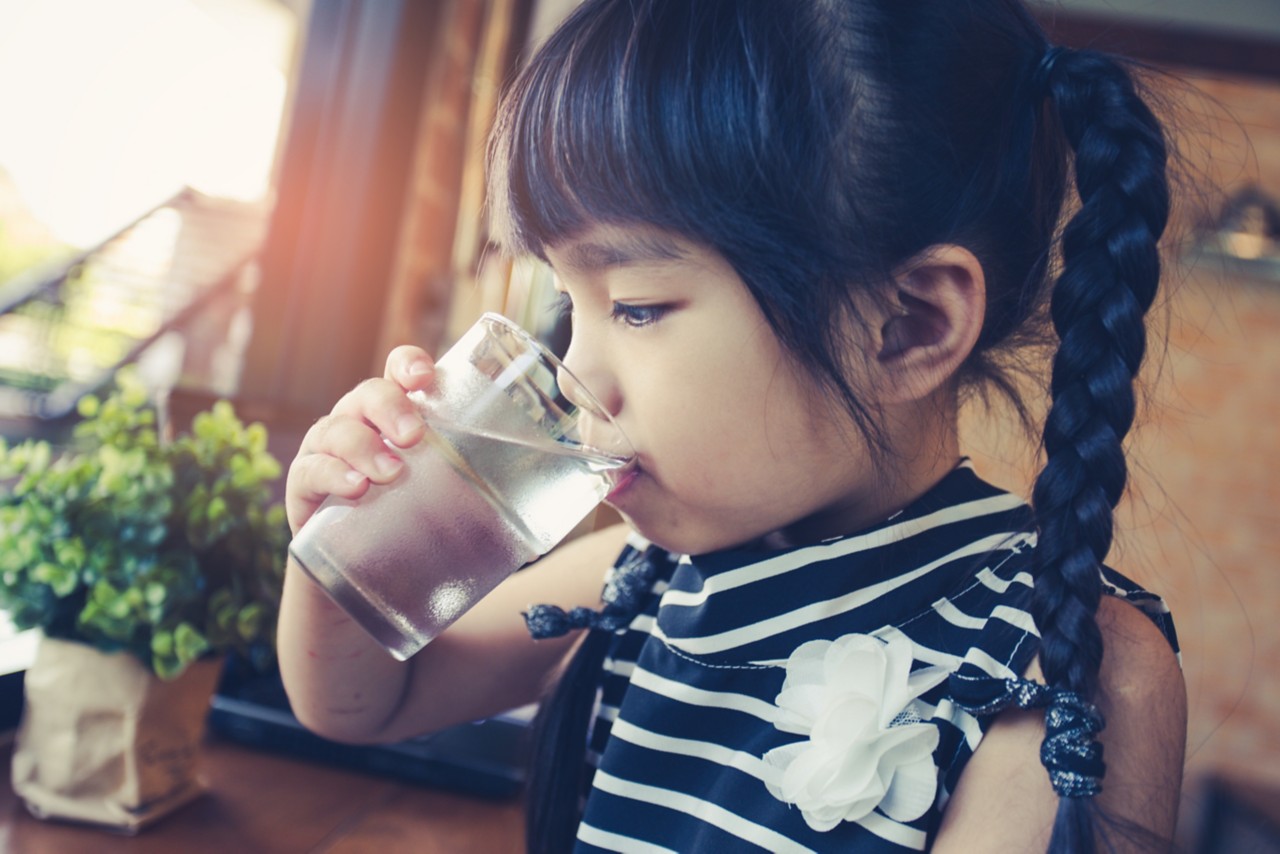 Little girl drinking water; filtered drinking water