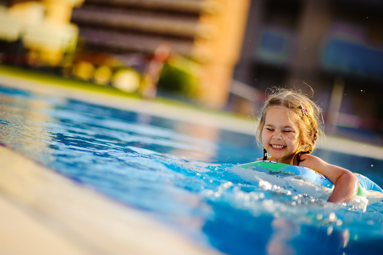 young-girl-swimming-in-blue-pool-outdoor-sunny-day-horizontal-full-size-image-file