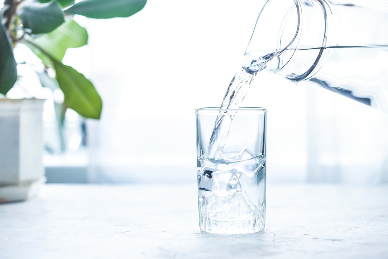 pouring-water-from-a-pitcher-into-a-glass-with-ice