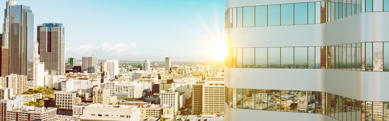 building with sunset behind it, over city view