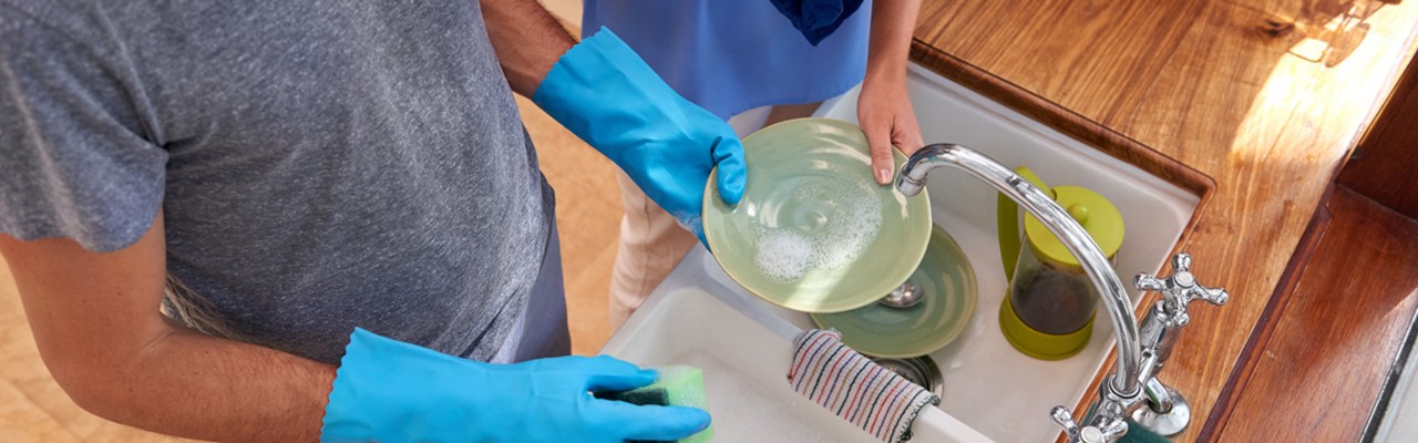 Over view of couple doing household chores in the kitchen