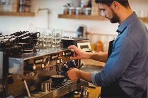 man taking coffee from espresso machine