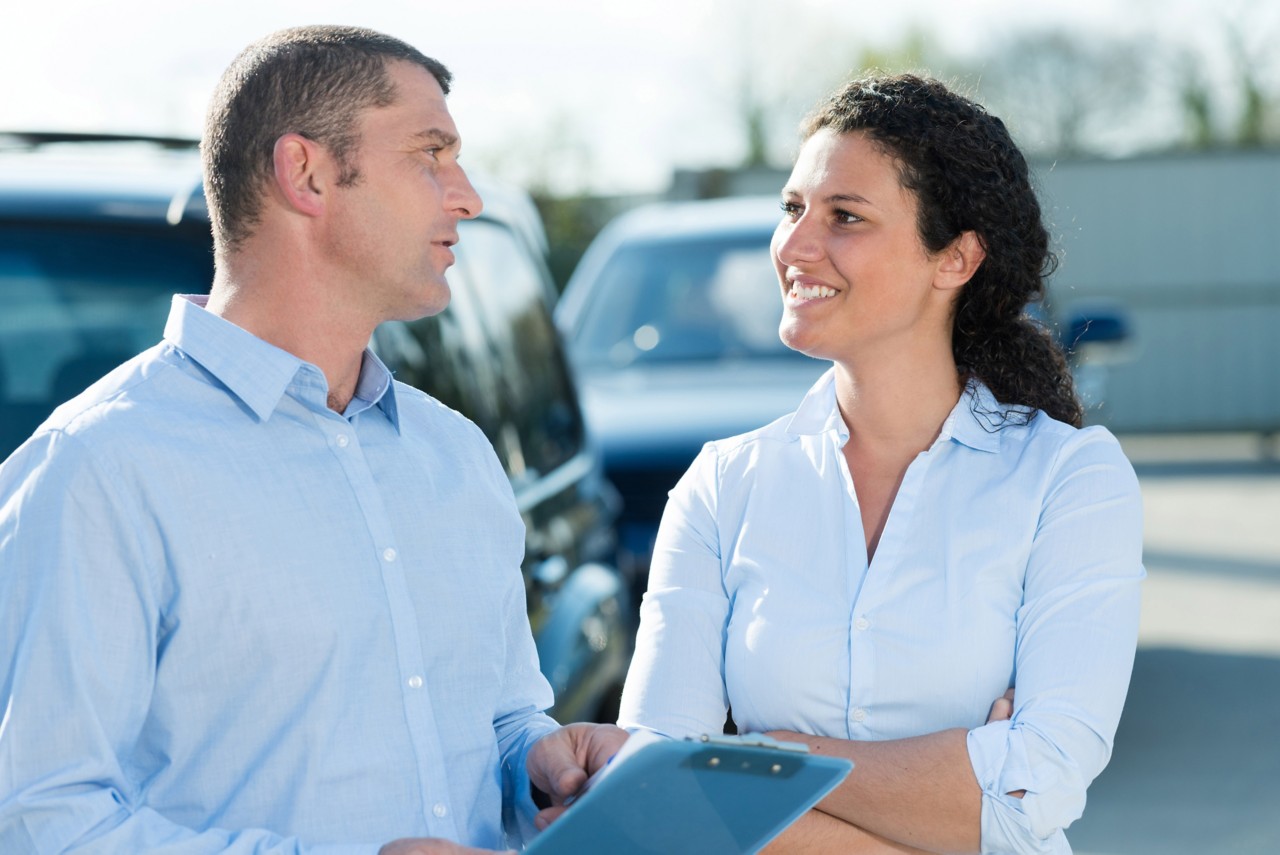 woman driver talks with insurance agent