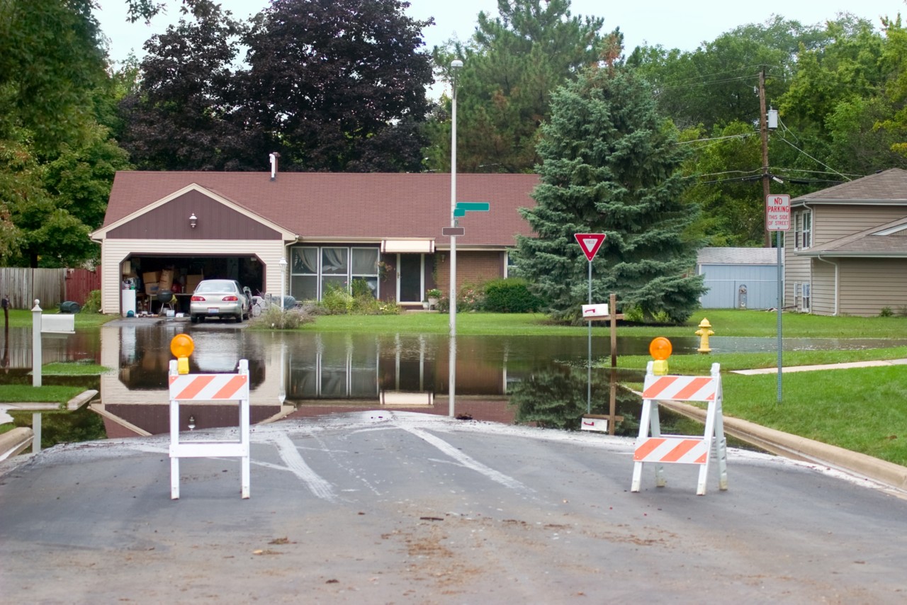 a flooded intersection of a suburban strreet is blocked in the aftermath of Hurricane IKE