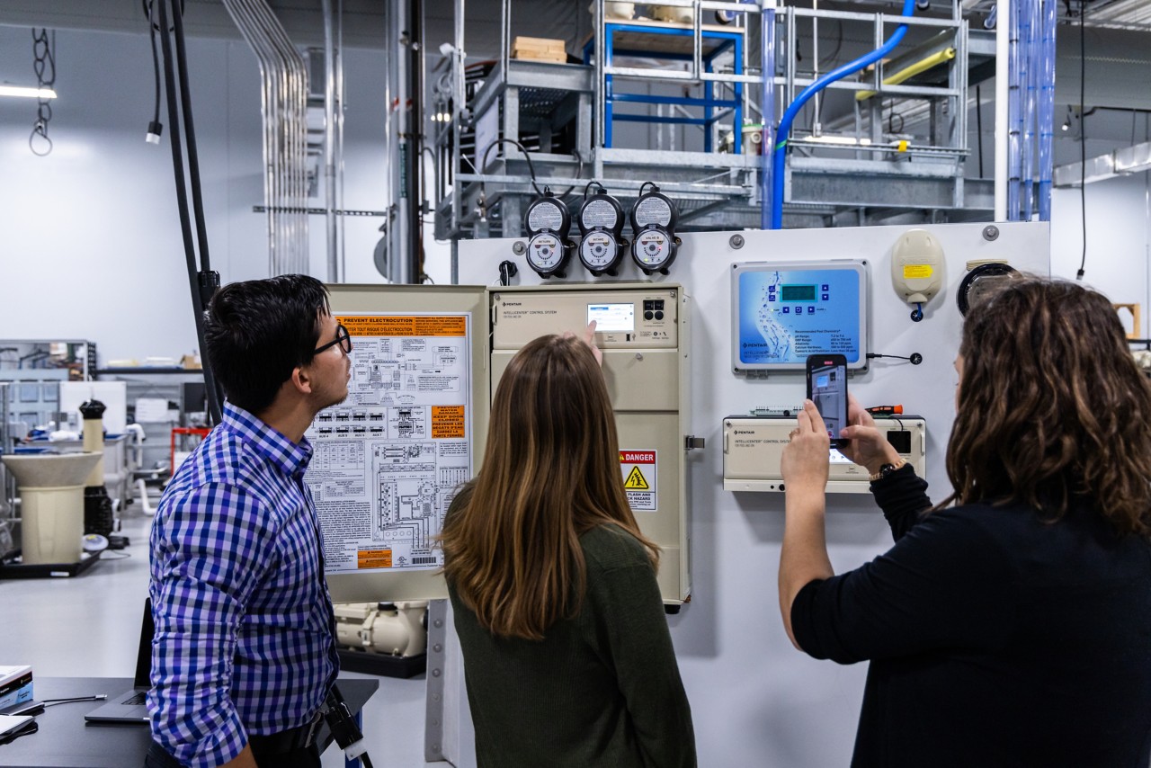 Three people reviewing the IntelliCenter Module