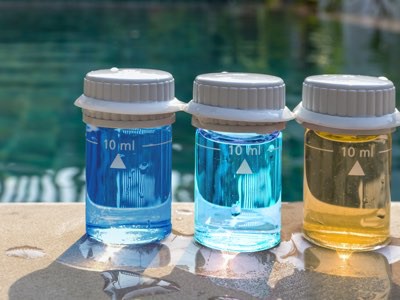 Three test samples of water. Dark blue, light blue, and yellow. 