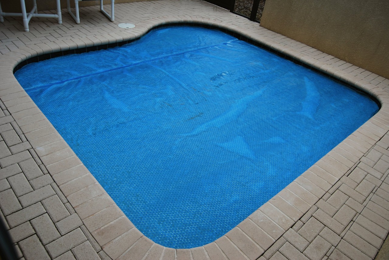 Home private swimming pool with cover on for winter fall