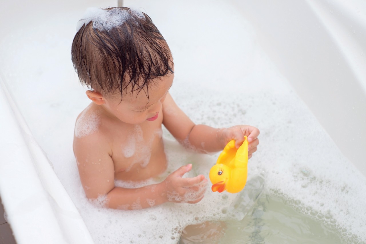 kid in bathrub with rubber duckie