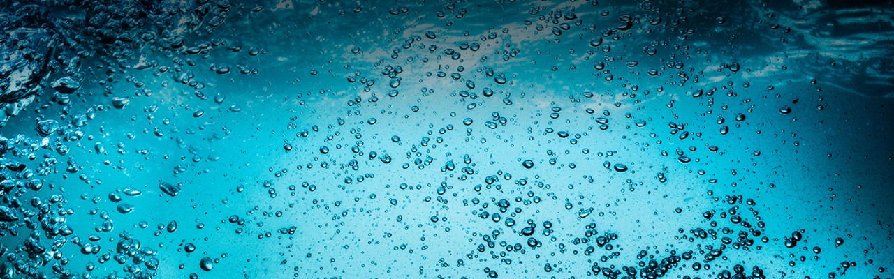 Many bubbles in water close up, abstract water wave with bubbles