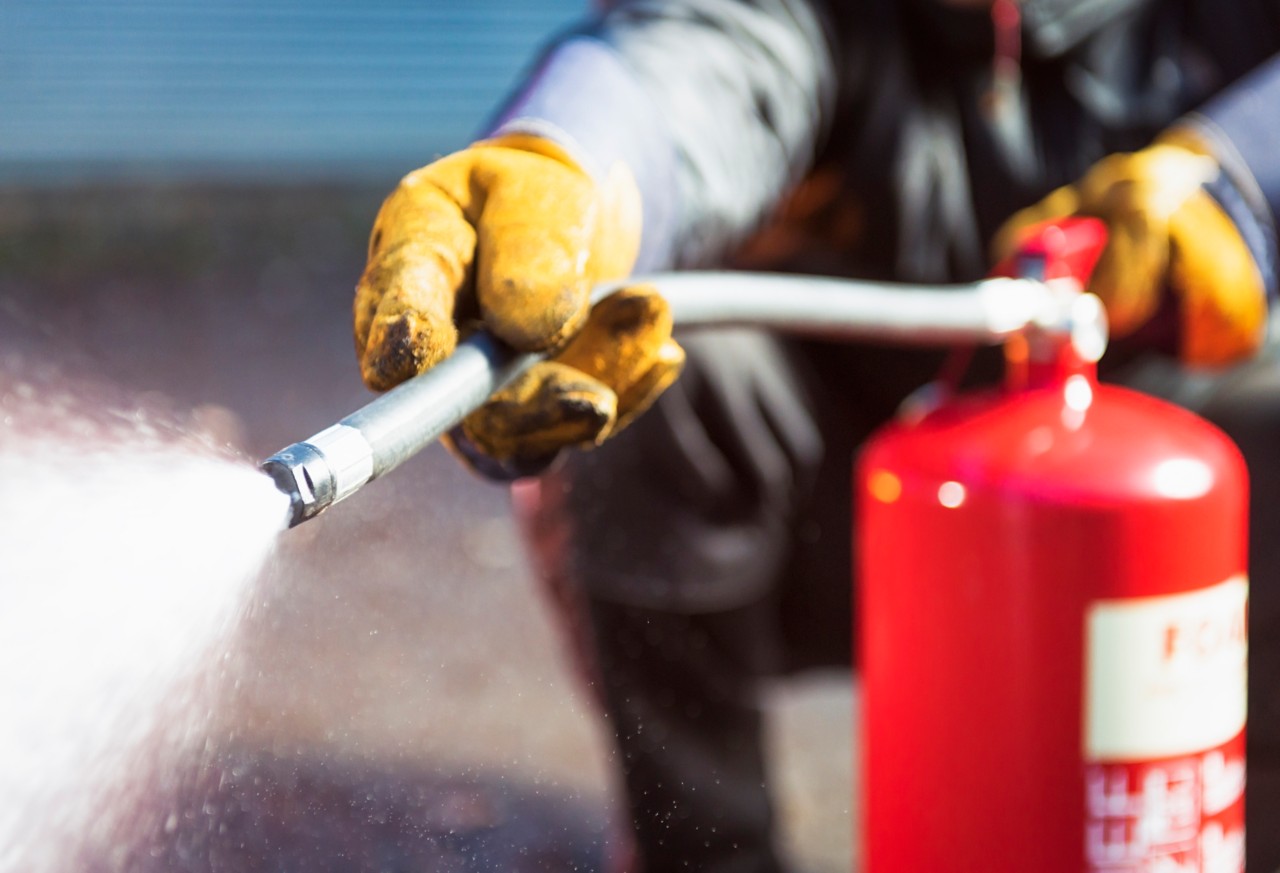 Close up as a foam fire extingusher is used