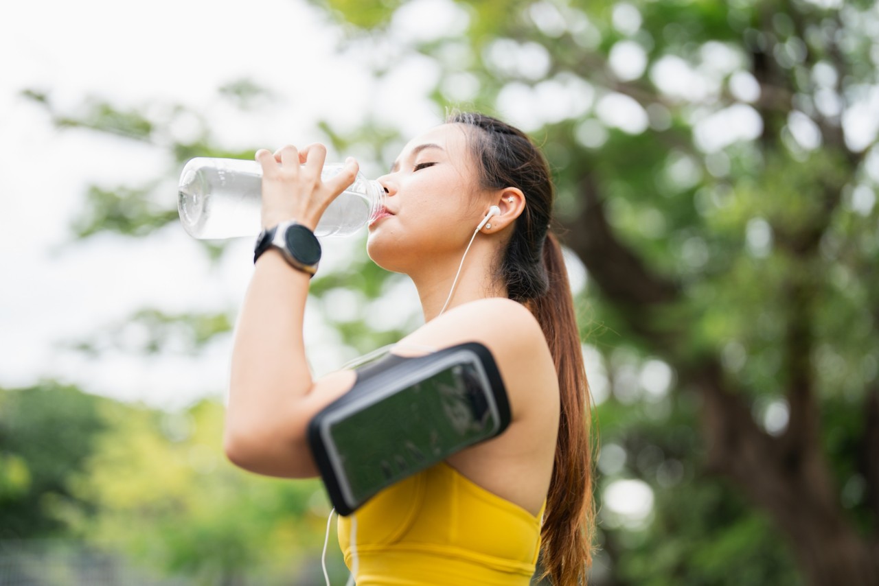 asian-sports-woman-drinking-water-from-a-bottle