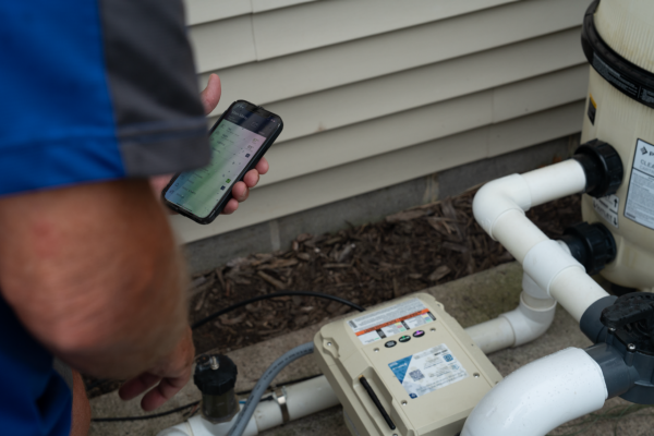 Installer with Phone Connecting to IntelliFlo3