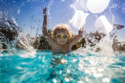 child swimming in pool