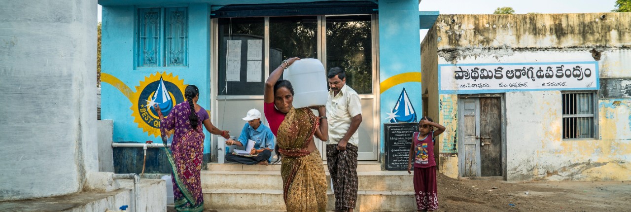 safe-water-network-woman-carrying-water-full-size-horizontal-4240x1425-image-file