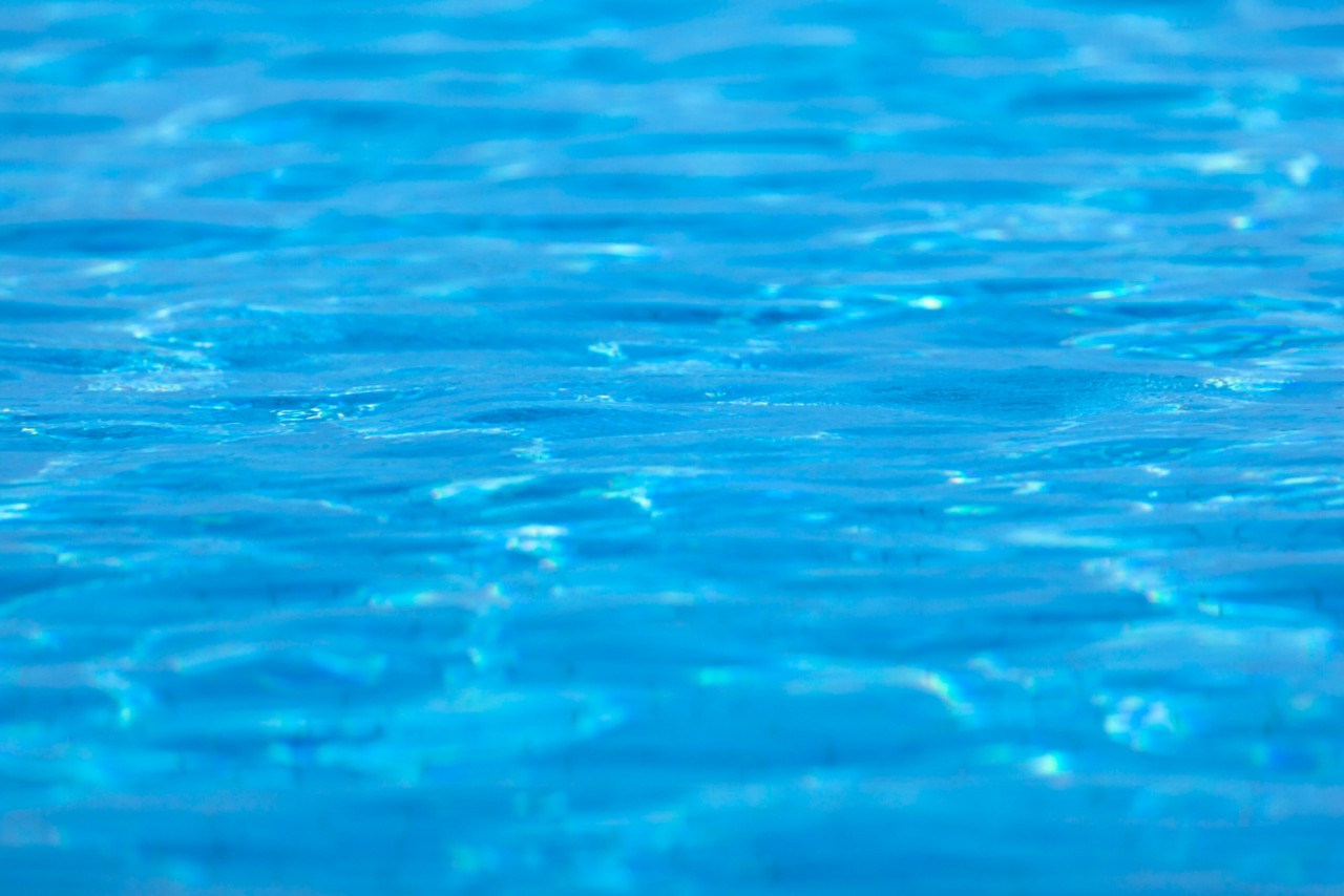 defocused shallow tiled swimming pool background.