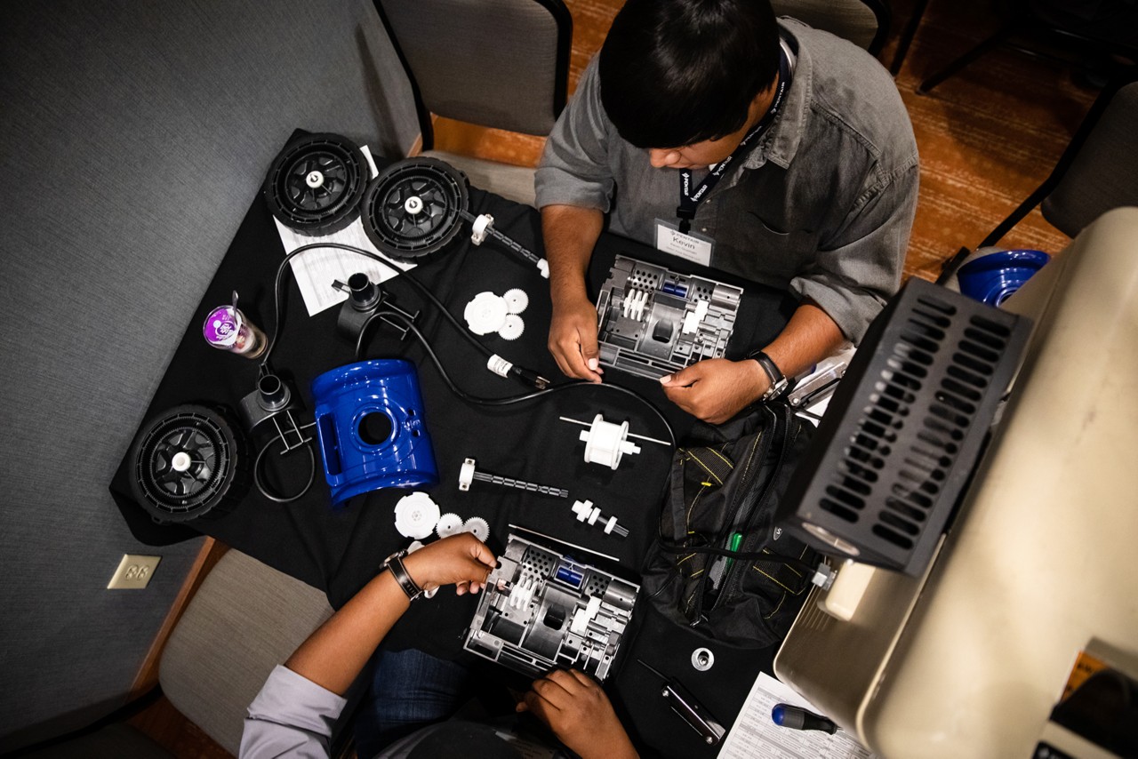 Kevin Guzman, pictured top, works with his brother Brian, to disassemble and then reassemble a Pentair Rebel suction side pool cleaner during a training class that was being held at the Doubletree Hotel conference center during the Pentair University training workshop, Phoenix, AZ, October 17, 2018.