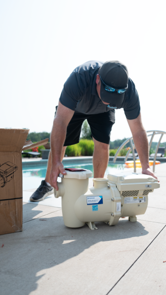 servicer fully unboxing IntelliFlo3 pump at Ham Lake, MN pool