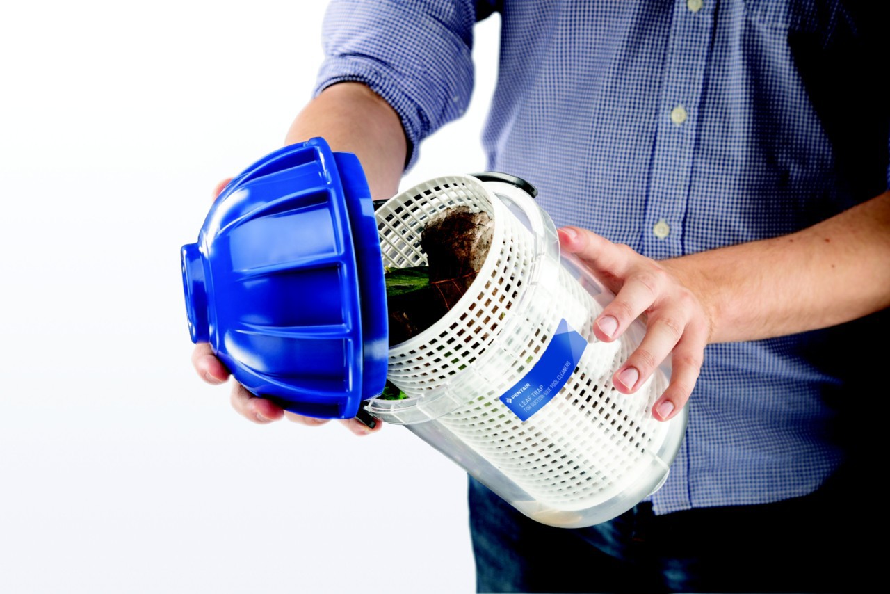man opening leaf trap canister