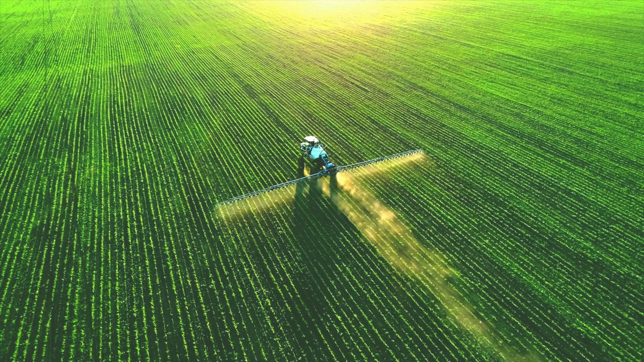 Tractor sprayer spraying crops