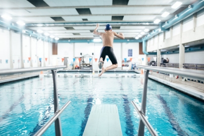 boy jumping in pool