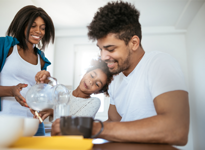freshpoint-family-woman-man-child-smiling-and-drinking-water-at-table-horizontal-679x496-image-file