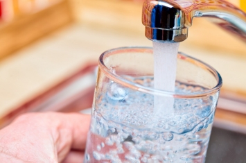 clean glass of water and faucet