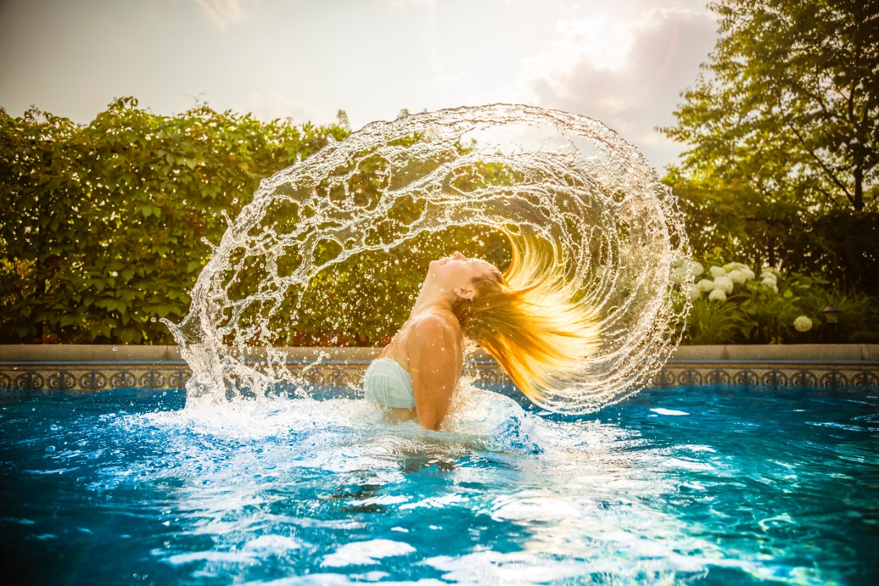 Woman throwing hair back in pool