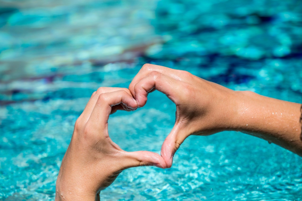 heart hands over pool