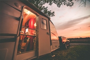 an RV at sunset with one open door