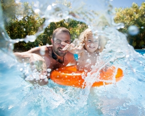 father son in tube in pool