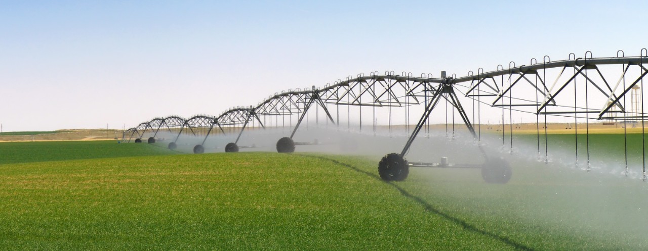 crop-irrigation-using-the-center-pivot-sprinkler-system-in-green-field-horizontal-3040x1181-image-file