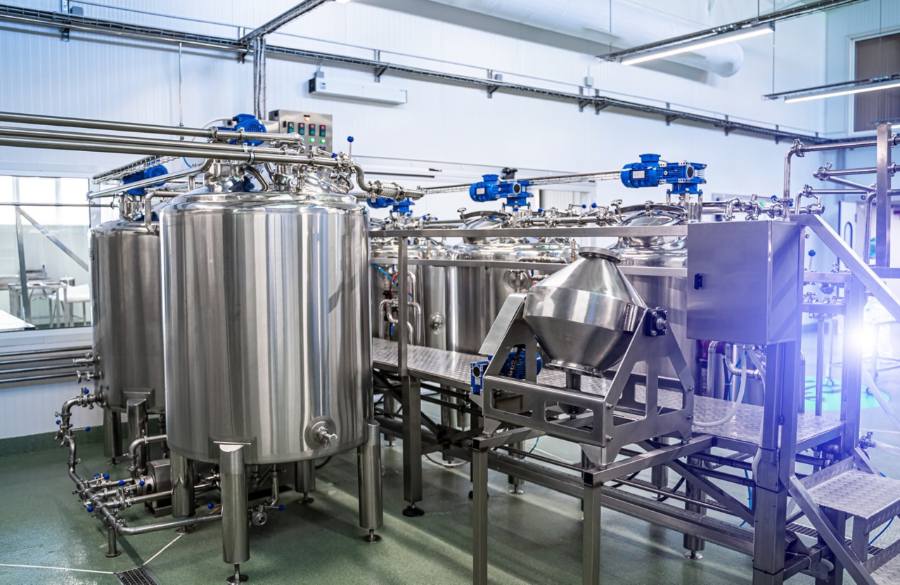 Interior of dairy factory with fermentation tank. Technology equipment at dairy farm. Sterile production.