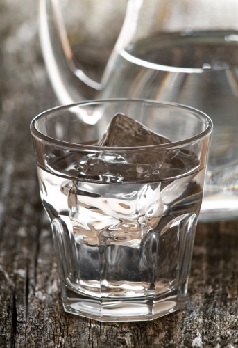 fresh water in glass with ice close up