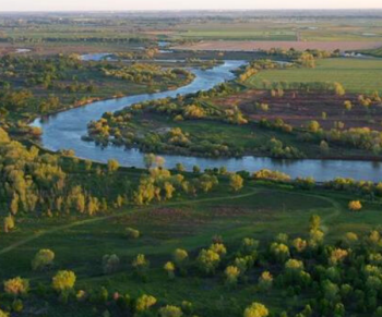 landscape image of winding river with trees from river partners grantee