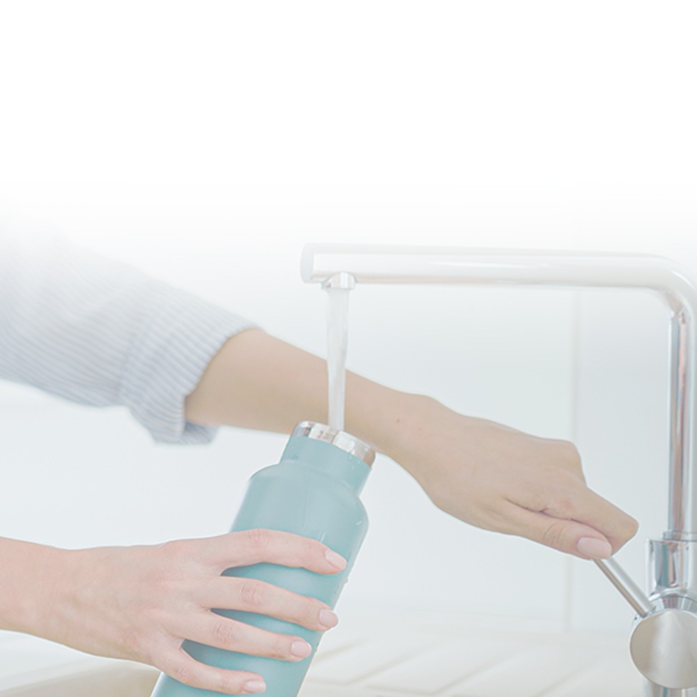 filling reusable water bottle under faucet