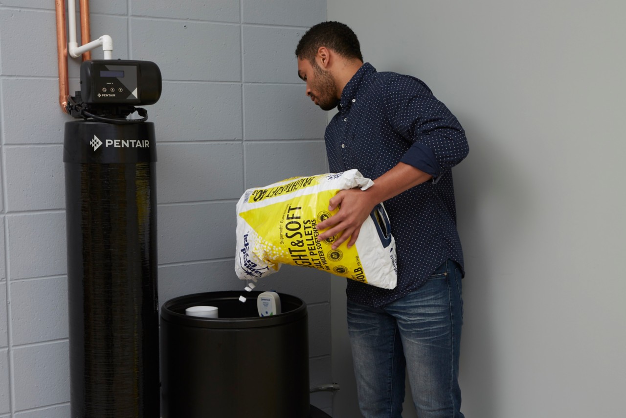 filling brine tank with bag of salt